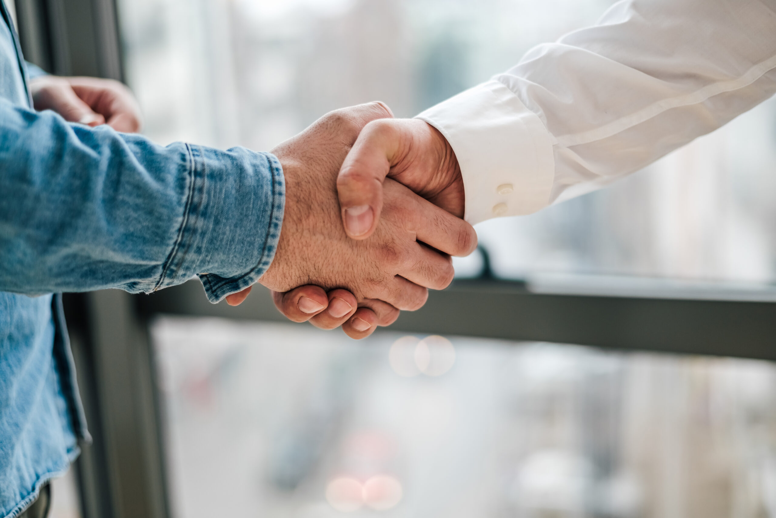 Two folks shaking hands at Aurora Auto Styling